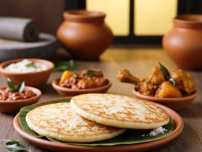 Freshly cooked Kerala kallappam (Fermented Rice Pancakes)served with chicken and potato curry and some side