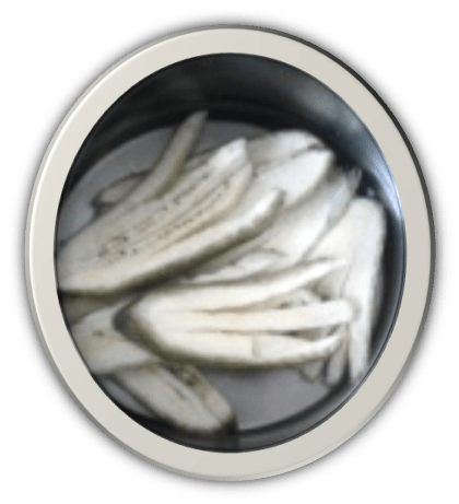 Raw unripe Kerala bananas sliced lengthwise for banana fingers recipe