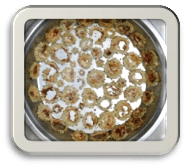 Bitter Gourd in a steel thali getting sun dried